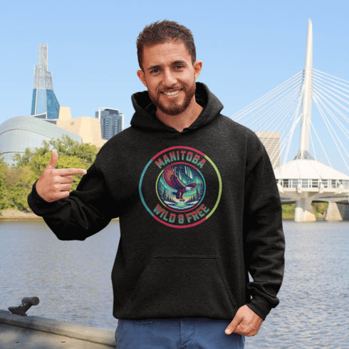 Soar high in our Manitoba – Wild & Free hoodie, featuring a bold flying bald eagle beneath the captivating northern lights.